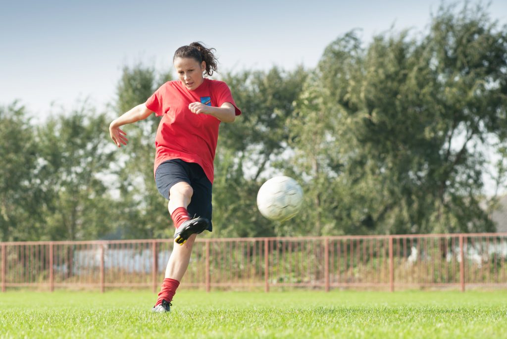 women kicking ball